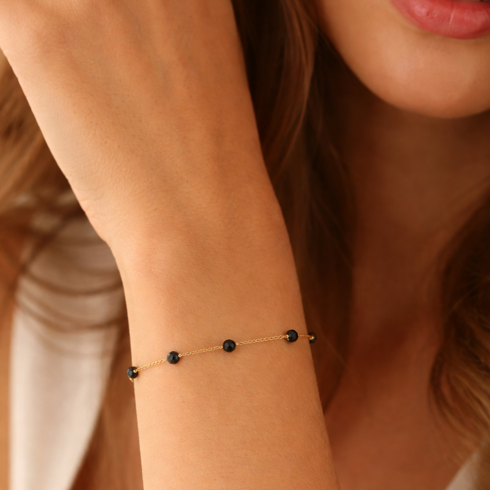 PULSEIRA EM OURO 19,2K C/ PEDRAS ONIX PRETAS